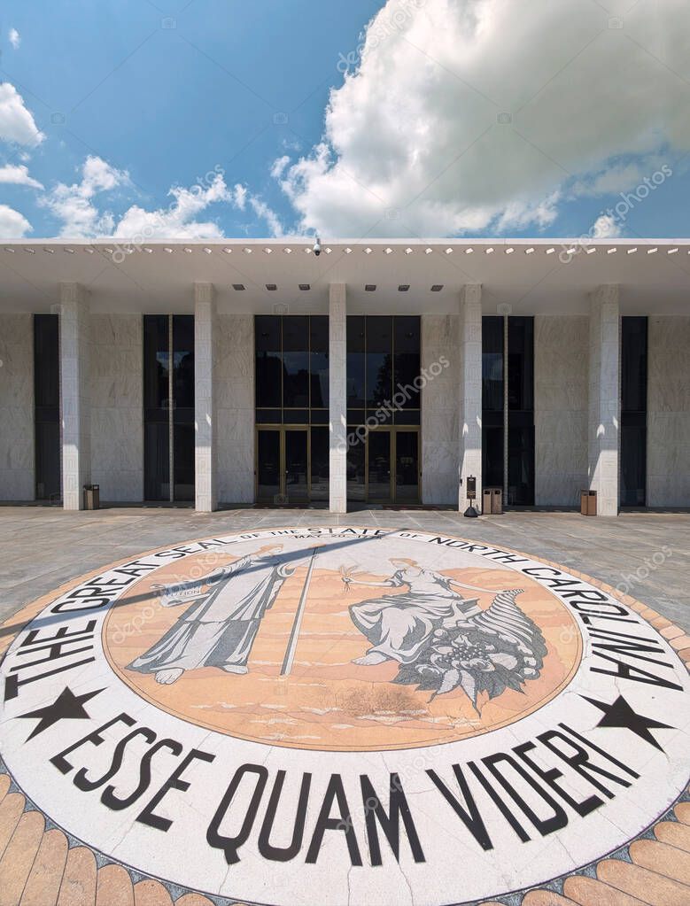 Raleigh, NC - USA - 8-16-2024: The State Legislative building in downtown Raleigh NC, and the North Carolina state seal and motto, Esse Quam Videri
