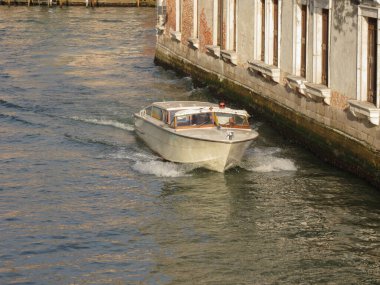 VENICE, ITALY - CIRCA JULY 2022: speedboat taxi in a canal