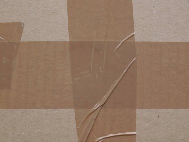 cardboard parcel sealed with adhesive tape useful as shipping concept or as background clipart