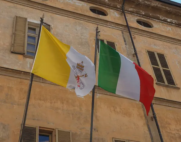 the Italian national flag of Italy, Europe and the Vatican national flag of Vatican City, Europe