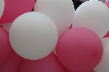 Beyaz ve pembe şişirilebilir hava balonları gaz veya hava ile dolu.