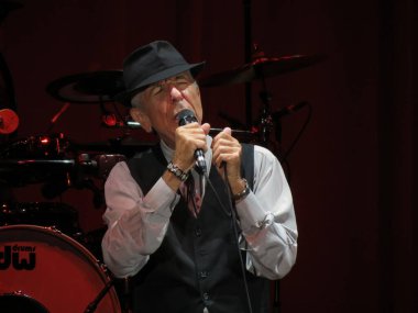 LUCCA, ITALY - JULY 09, 2013: Leonard Cohen performing live during evening show clipart