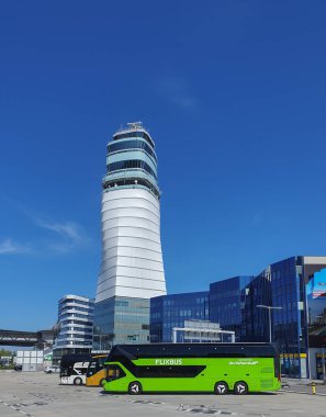 VIENNA, AUSTRIA - APRIL 13, 2024: Schwechat airport control tower and bus parking clipart