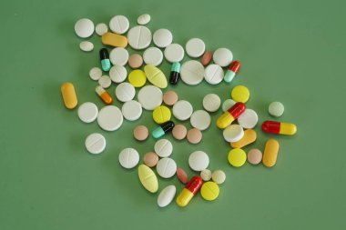 Yeşil arka planda haplar ve kapsüller