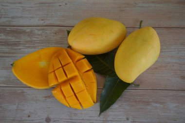 Ahşap arka planda doğranmış mango meyvesi