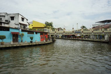 Melaka, Malaysia-June 30, 2024; view of Melaka river with modern and historic building clipart