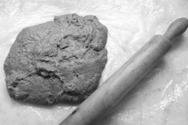 cocoa flavored dough ready to be stretched, in black and white