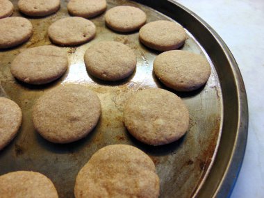 recently  baked cocoa flavoured cookies in metalic tray