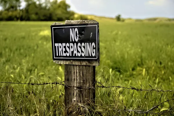Trespassing Sign Field Barbed Wire Wooden Post Royalty Free Stock Images