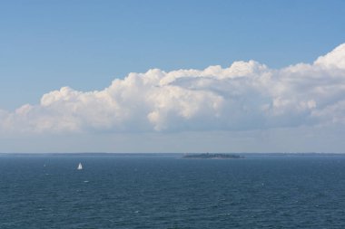Finlandiya 'da küçük bir teknesi olan küçük bir ada güneşli bir günde açık denizde golf oynuyor.