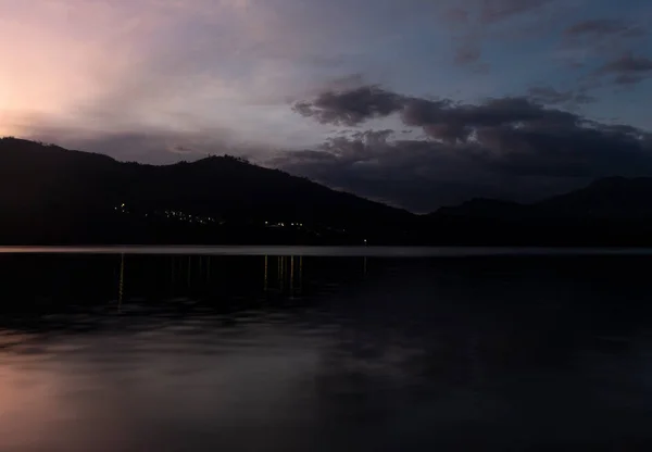 stock image Beautiful purple and blue dusk on mountain and lake landscape with water silk effect