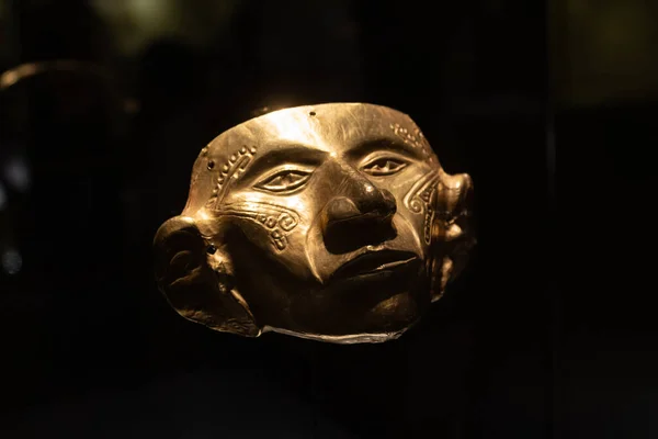 stock image Beautiful ancient golden mask with carved like a face painting imitations at golden museum