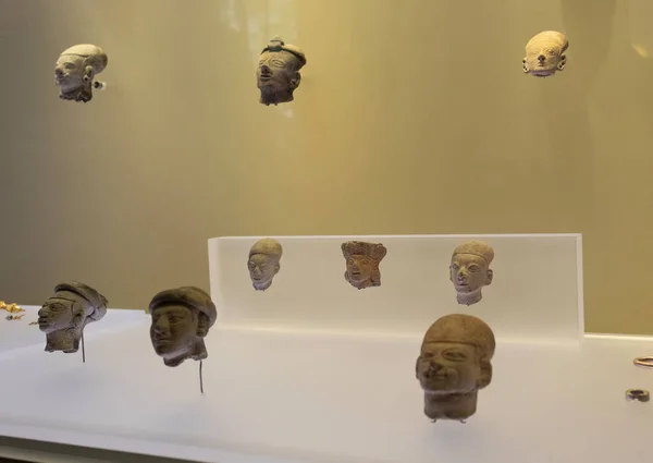 stock image Beautiful ancient ceramic small heads of tumaco colombian culture inside golden museum