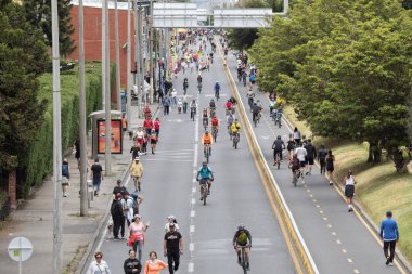 9th avenue at north of the city full of people doing sports during ciclovia event on sunday clipart