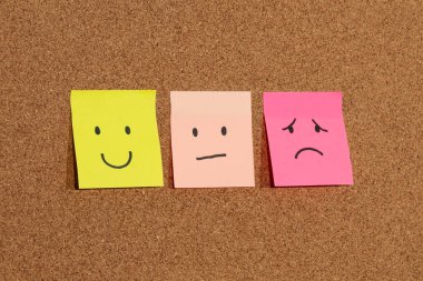 Mantar arkaplan üzerinde insan duygularını yansıtan üç yapışkan notaya yaklaş