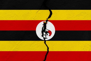 Uganda Cumhuriyeti bayrağı, bir grunge çatlağı duvarına saplandı. Jeopolitik ve doğal afet kavramı