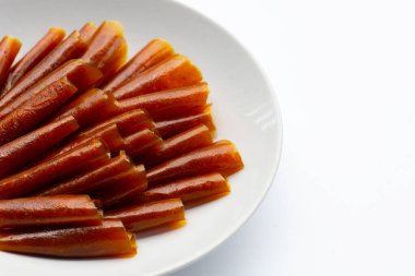 Dried mango paste sheets on white background.