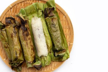 Grilled sticky rice in banana leaves with banana filling