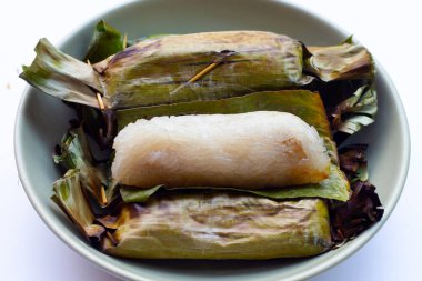 Grilled sticky rice in banana leaves with banana filling