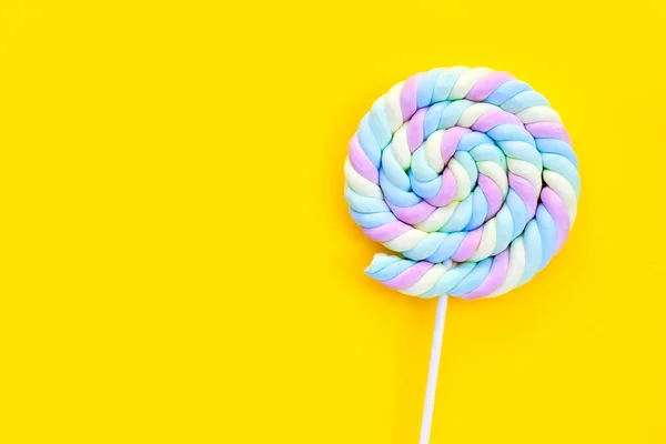 Round and twisted colorful marshmallow lollipop with stick