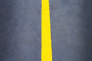 Yellow line on black walkway