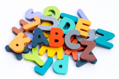 Colorful wooden alphabets on white background.