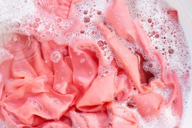 Top view of formal shirts soak in powder detergent water dissolution. Laundry concept