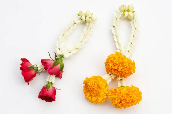 Jasmine and crown flower garland with rose and marigold flower on white background