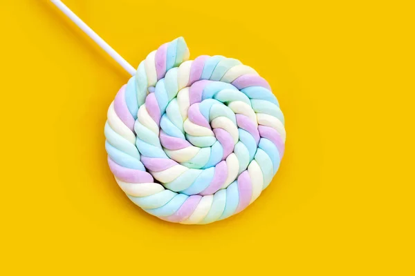 Round and twisted colorful marshmallow lollipop with stick