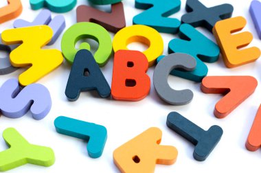 Colorful wooden alphabets on white background.