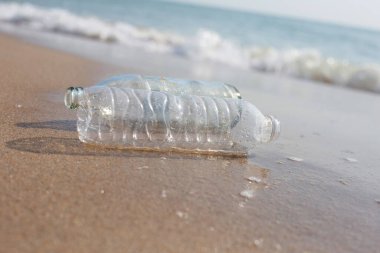 Plastic with glass bottle on the beach