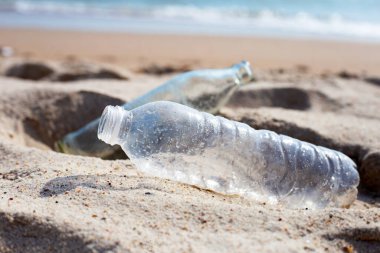Plastic with glass bottle on the beach