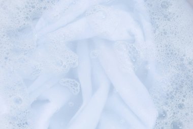 Top view of towel soak in powder detergent water dissolution. Laundry concept