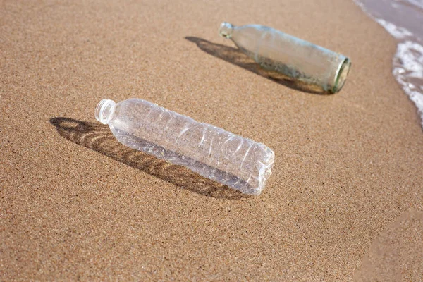 Plastic with glass bottle on the beach