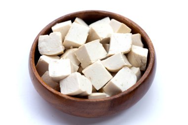 White tofu in wooden bowl on white background