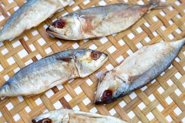 Salted fish on bamboo weave plate