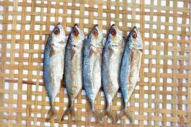 Salted fish on bamboo weave plate