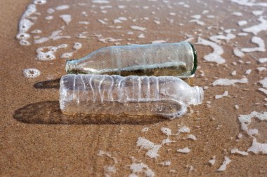 Plastic with glass bottle on the beach
