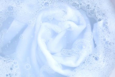 Top view of towel soak in powder detergent water dissolution. Laundry concept
