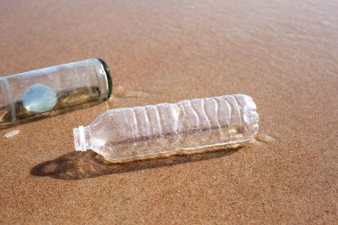 Plastic with glass bottle on the beach