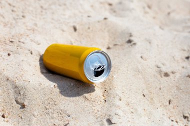 Yellow can waste on the beach