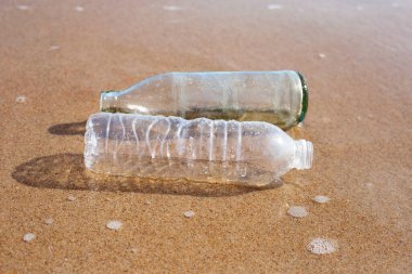 Plastic with glass bottle on the beach