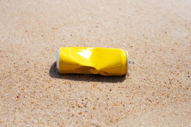 Yellow can waste on the beach