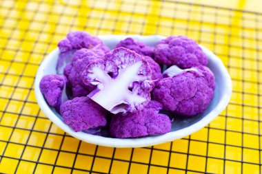 Purple cauliflower on yellow background.