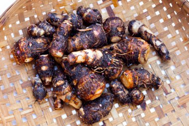 Organic taro fruit in bamboo weave plate