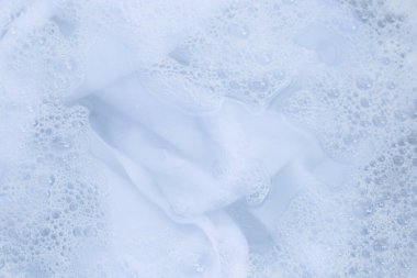 Top view of towel soak in powder detergent water dissolution. Laundry concept