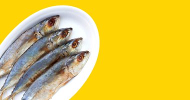 Salted fish on yellow background.