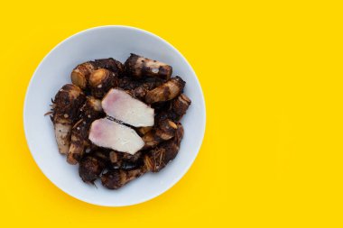 Boiled taro on yellow background.