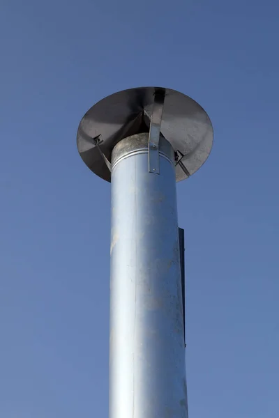 stock image Metal chimney pipe on the roof of house