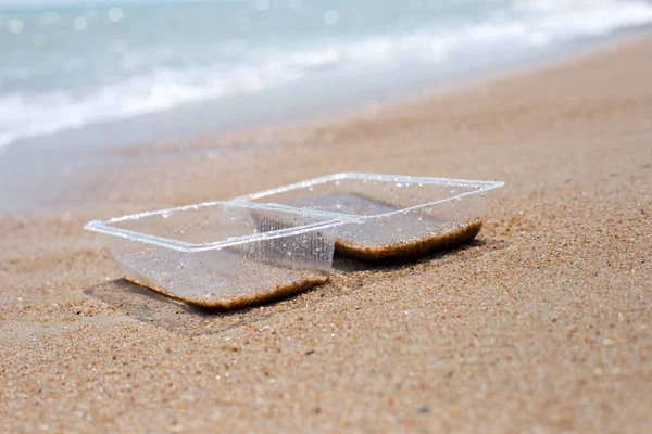 Plastic food container on the beach